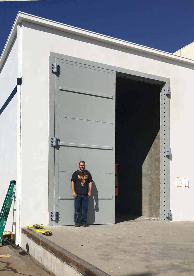 The pair of hybrid doors, each leaf of which measured 8 feet wide (16 feet total width of both doors) by 20 feet high by 3 inches thick, had a Sound Transmission Class (STC) rating of 50.